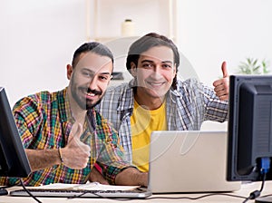Two it specialists working in the office