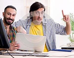 Two it specialists working in the office