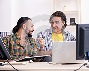 Two it specialists working in the office