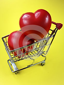 Spongy red hearts in shopping cart photo