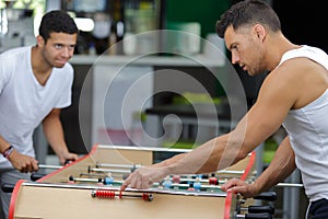 Two sportmen playing football table