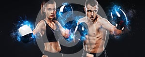 Two sportsmans, woman and man boxers fighting in gloves on black background. Boxing and fitness concept.