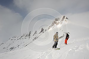 Two sportsmen gliding from top of mountain