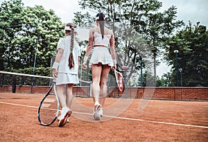 two sporty female athlete on tennis court photo