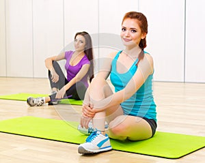 Two sporty women at fitness club