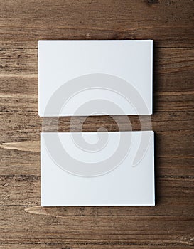 Two stack of blank white business cards on wooden background Vertical