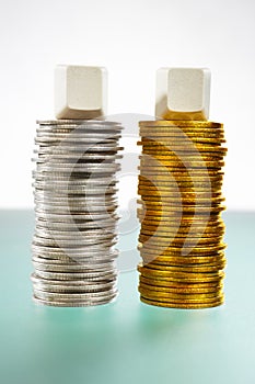 Two stack of silver and gold coins