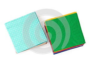 Two stacks of colorful paper napkins on white background