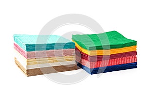 Two stacks of colorful paper napkins on white background