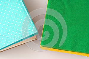 Two stacks of colorful paper napkins on white background