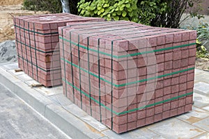 Two stacks of concrete pavement tiles