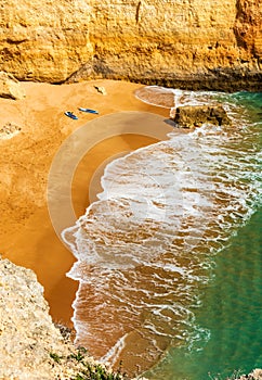 Two stand up paddling boards relaxing at the beach - vertical