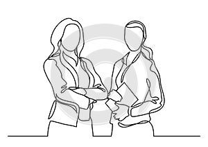 Two standing business women - continuous line drawing