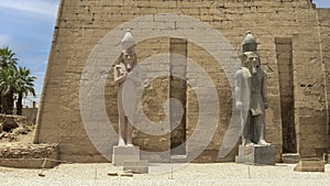 Two standing statues of Rameses II at the 1st Pylon, the main entrance for  the Luxor Temple in Luxor, Egypt.