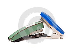 Two staplers fighting, stapling, biting each other. New vs old fight, new winning Office war, desk accessories duel, brawl photo