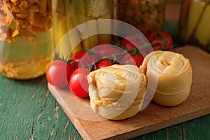 Two steamed rolled cheeses on green table