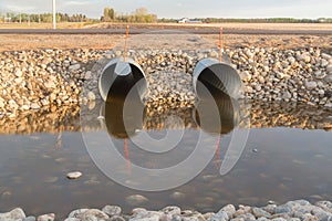 Two steel culverts surrounded by rocks