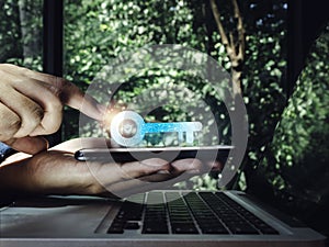 Two steps authentication concept. Virtual key icon on smartphone in hand with laptop for validate password, Identity verification.