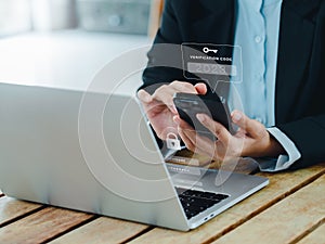 Two steps authentication 2FA concept. 2023, Verification code and key icon alert on smart phone while using computer.