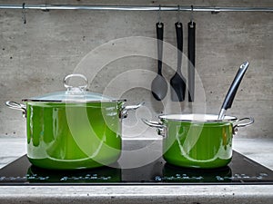 Two stewpots on induction cooker