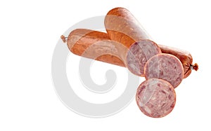 Two sticks of smoked sausage in a natural shell, located one above the other, with cut slices, isolated on a white