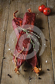 Two sticks of sujuk on wooden table