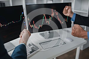 Two stock investors working together to analyze the stock market, business man is trading stocks for profit, stock market up and