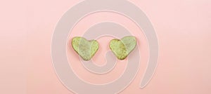 Two stone hearts  on pastel pink background .Feelings of stone heart for concept background .   Valentines Day card. Copy space