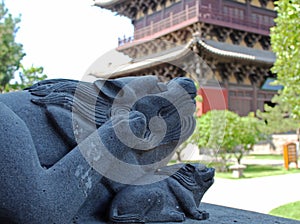 Two stone lions and pagoda in Chinese Buddhist temple Huayan Monastery