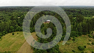 Two-storey wooden house hill green forest. village Russian general Suvorov.