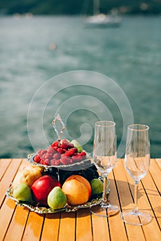 Two-storeyed plate with fruits: raspberries, peach, apples, figs