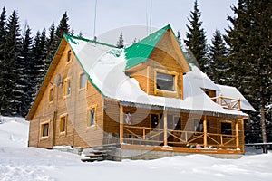 Two-storeyed wooden house concealed by snow