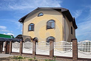 Two-storeyed yellow brick cottage