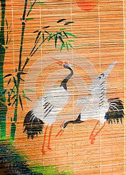 Two storks on a wooden background