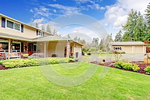 Two story house with attached garage and open column porch