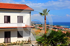 Two-story house with brown roof and stairs