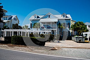 Two-story houses with white pergola, metal roof and curb appeal along scenic 30A country road in Santa Rosa, South Walton near
