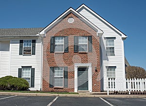 Two Story Red Brick with White Siding Apartment Building Entrance