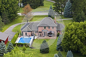 Two-story residential house with swimming pool in rural living area in Rochester, NY. American dream home as example of