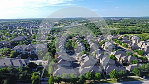 Two story single family houses near new development apartment complex surrounding by lush green trees along Brushy Creek Road with