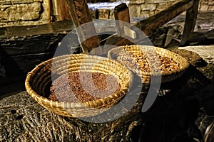 Two straw scuttles with linseed and fruit-stones photo