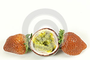 Two Strawberries and a Sliced Passion Fruit on White