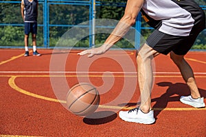 Two street basketball players playing on court.