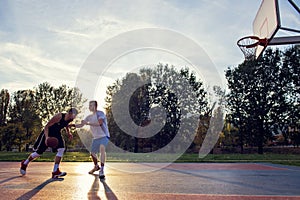 Two street basketball players playing hard on the court