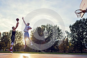 Two street basketball players playing hard on the court