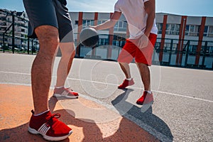 Two street basketball players playing one on one lot of close up action and guarding the ball