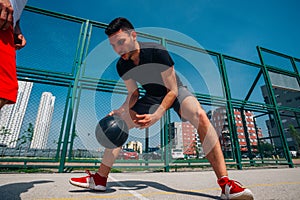 Two street basketball players playing one on one lot of close up action and guarding the ball