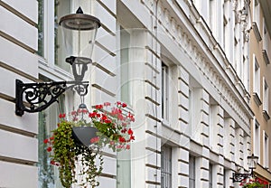 Two Streetlamps on a Historic Building's Facade