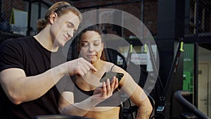 Two strong athletes are talking and looking at the phone