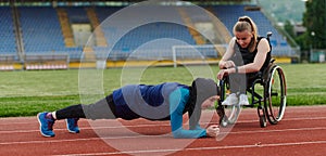 Two strong and inspiring women, one a Muslim wearing a burka and the other in a wheelchair stretching and preparing